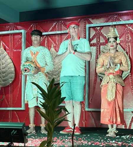 Me on stage with 2 Apsara dancers dressed in traditional Cambodian clothes