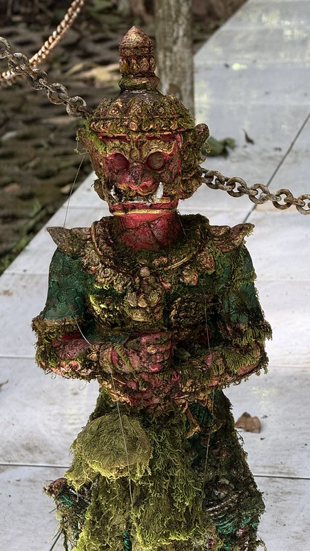 A dragon guard covered in moss