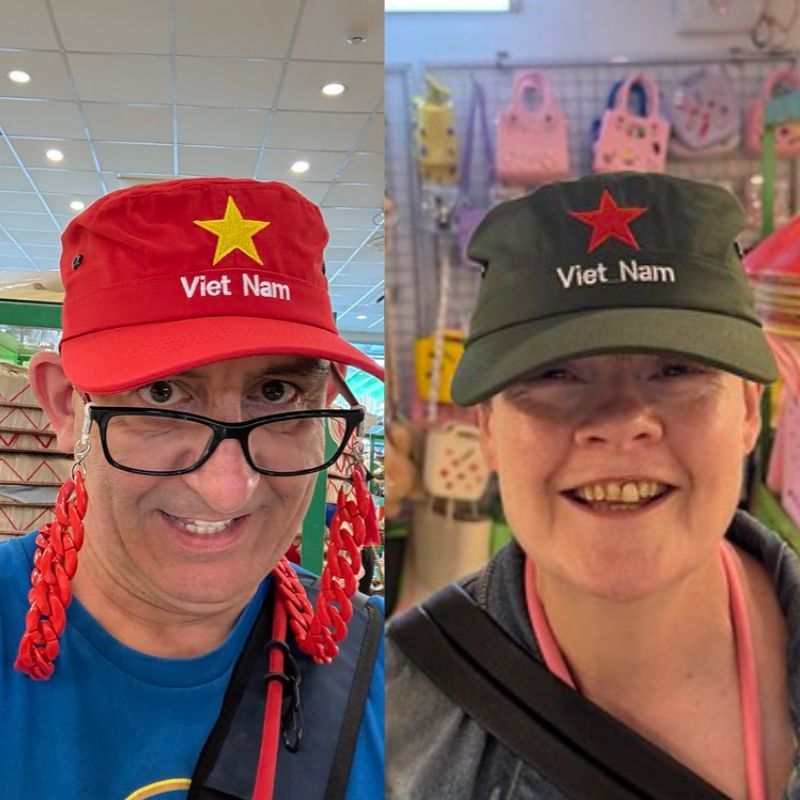 Susan & I wearing our new military caps, on the left is me wearing a red cap with a yellow star below with is the words Viet Nam. Susan's hat is the same but Olive coloured with a red star